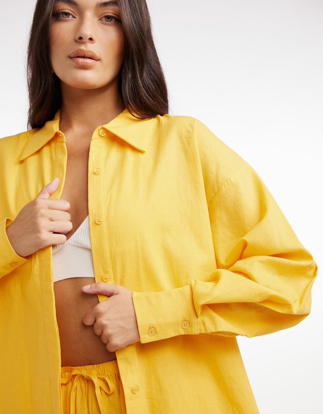 A fun casual day shirt in pop of fabulous yellow. This is fresh and casual perfect for running around and adding some sunshine to any day. Jeans, shorts, pants, this can be worn layered over a tee for a relaxed look.