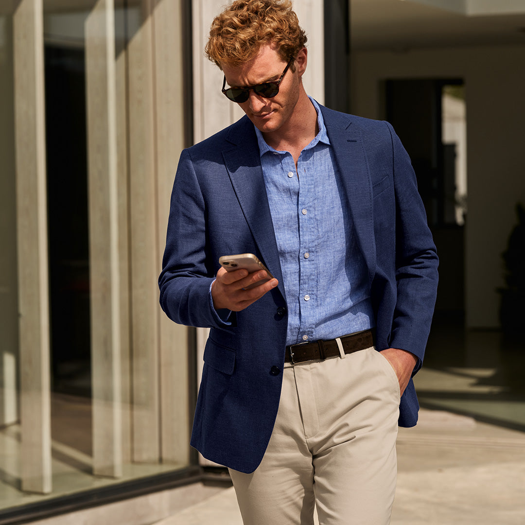 <img src="path/to/man-business-casual-attire-using-phone.jpg" alt="Man in business casual attire using a phone">